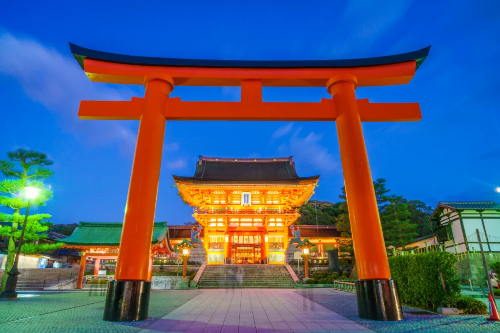 Templo en Kioto con torii rojo iluminado de noche